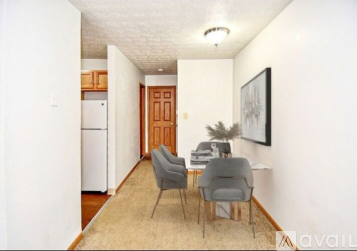 A living room with a dining table and chairs.
