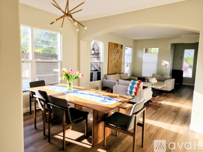 A dining room with a wooden table and chairs.