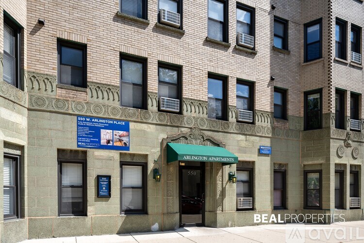 The building is a brick apartment with a sign that says Arlington Apartment.