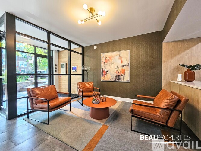 A living room with a brown leather chair and a coffee table.