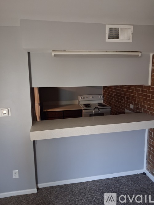 A kitchen area with a stove and a counter.