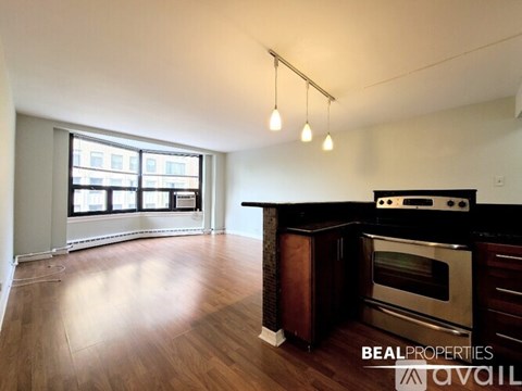 A kitchen with a stove and oven is available for rent.