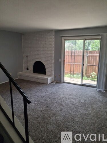 A living room with a fireplace and sliding glass doors.
