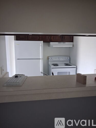 A white fridge and a white oven are in a kitchen.
