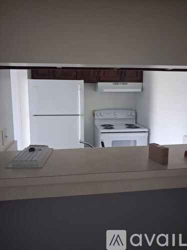 A white fridge and a white oven are in a kitchen.