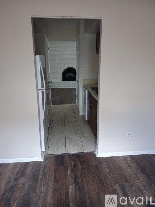 A kitchen with a white fridge and a white oven.