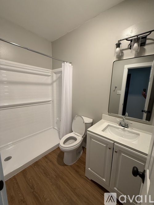 A white bathroom with a toilet, sink, and bathtub.