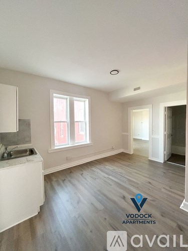 A Vodock Apartments sign is displayed in an empty living room.