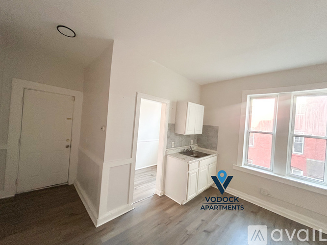 A Vodock Apartments listing shows a small, empty kitchen with white cabinets and a window.