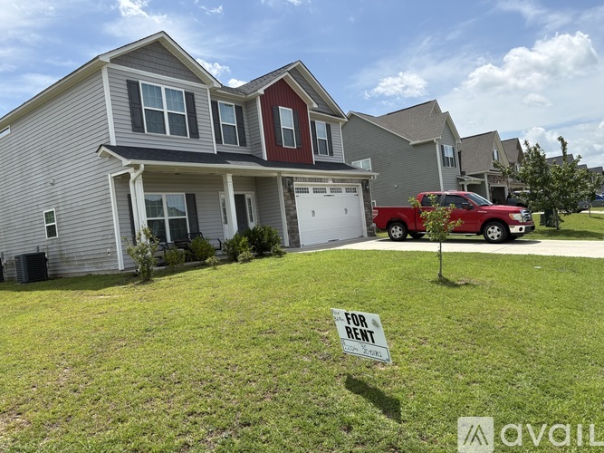 A house with a for rent sign in front of it.