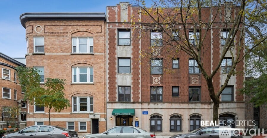 A large brick building with a green awning and the words "Beal Properties" on the front.