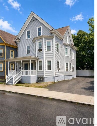 A two-story house with a front porch is for sale.