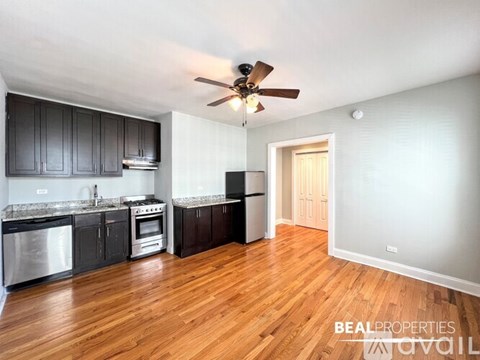 A kitchen with dark wood cabinets and a white fridge.