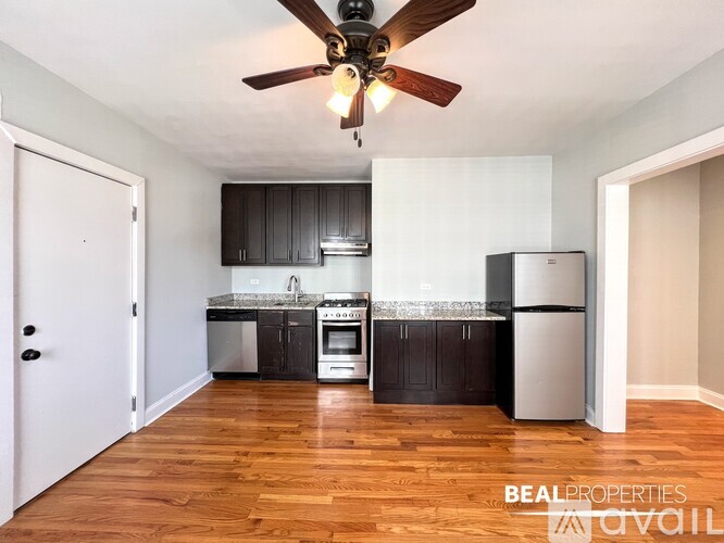 A kitchen with a refrigerator, oven, and sink is on the market.
