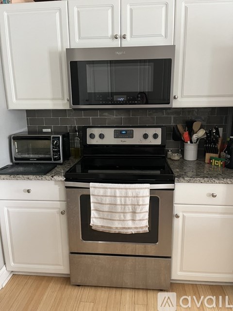 A kitchen with a black microwave and oven.