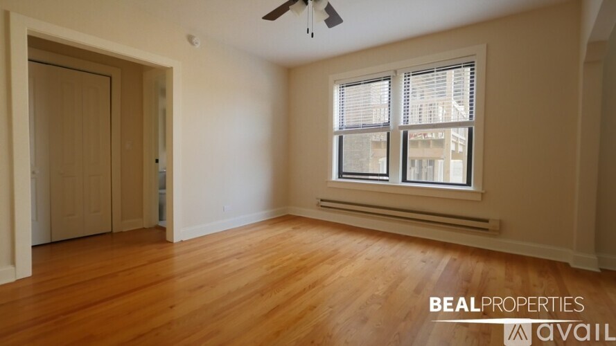 A room with a window and a ceiling fan.
