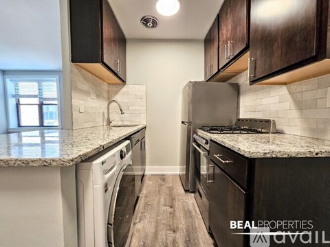 A kitchen with a washer and dryer built in.