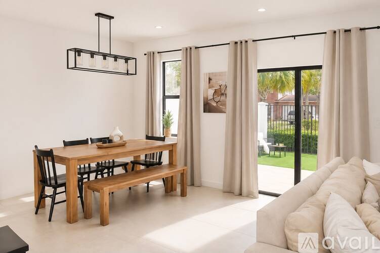 A modern dining room with a wooden table and chairs.