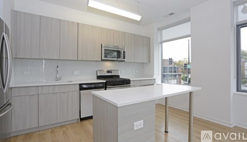 A kitchen with a white countertop and a microwave above it.
