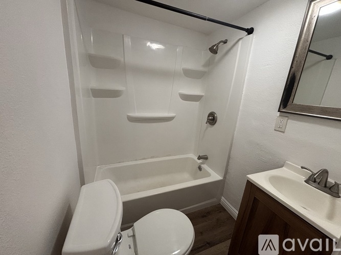 A bathroom with a toilet, sink, and bathtub.
