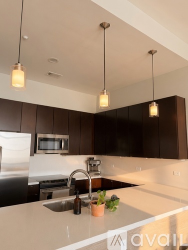 A kitchen with a white counter top and brown cabinets.