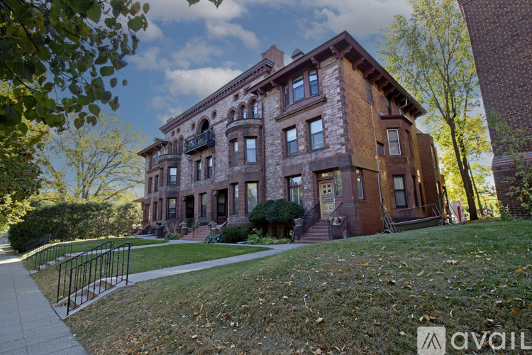 A large brown building with a balcony on the second floor.
