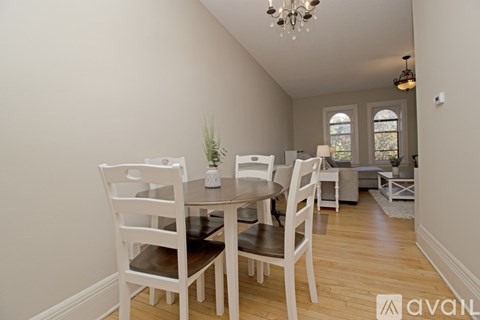 A dining room with a table set for four.