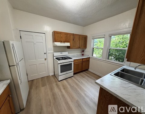 A kitchen with a refrigerator, stove, and oven.