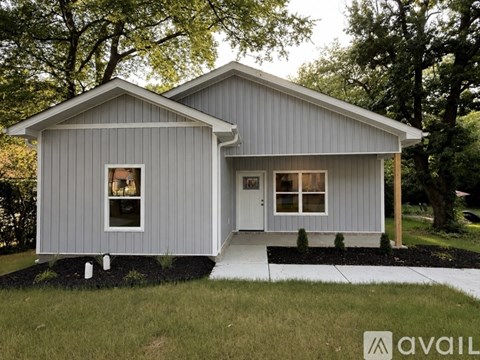 A modern house with a grey exterior is available for purchase.