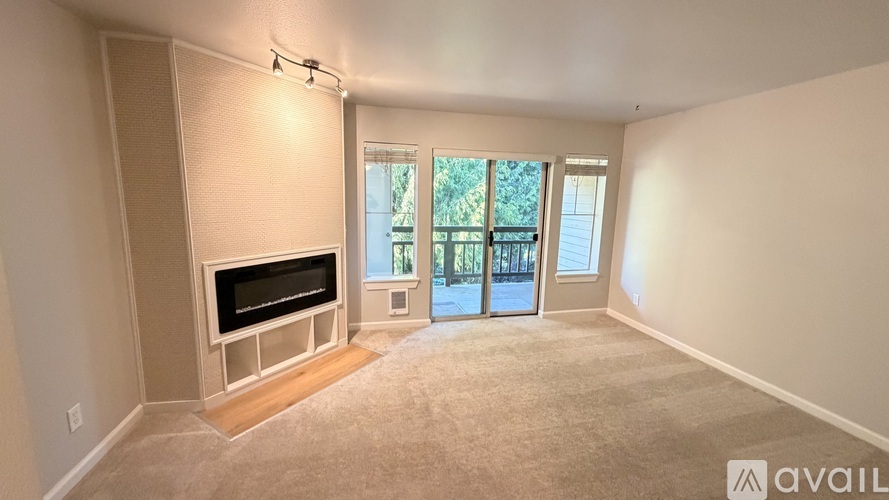 A living room with a television and sliding glass doors.