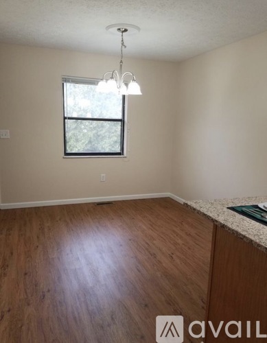 A room with wooden floors and a window.