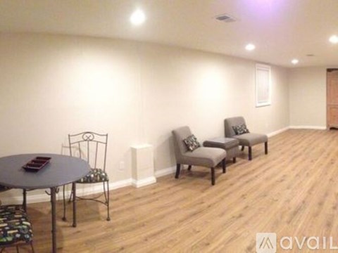 A living room with a table and chairs.