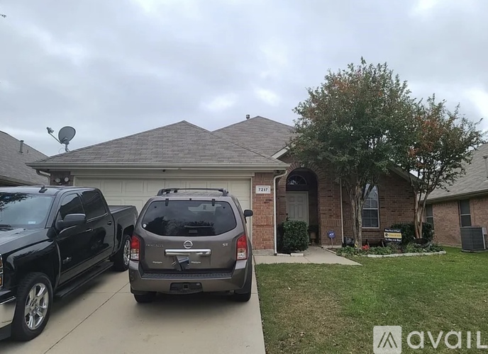 A silver SUV is parked in front of a house.
