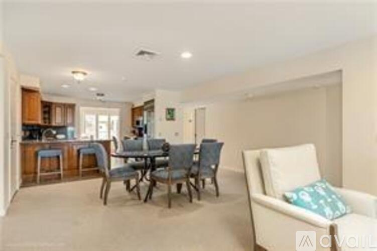 A living room with a dining table and chairs.