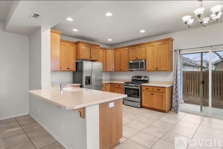 A kitchen with wooden cabinets and a white island.