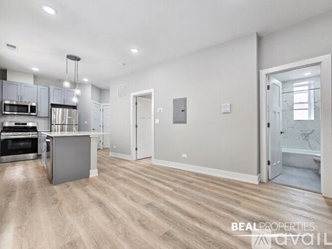 A spacious kitchen with a dining area and a living room.
