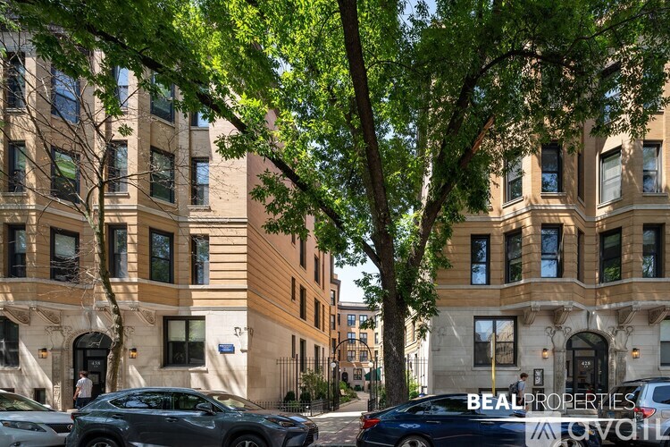 A street view of a building with cars parked on the side.