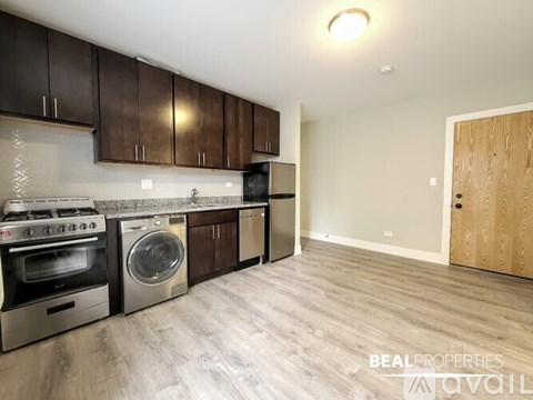 A kitchen with dark brown cabinets and stainless steel appliances.
