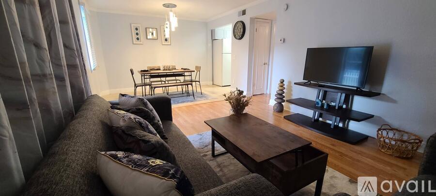 A living room with a grey couch and a wooden coffee table.