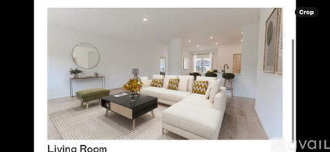 A living room with a white sofa and a coffee table.