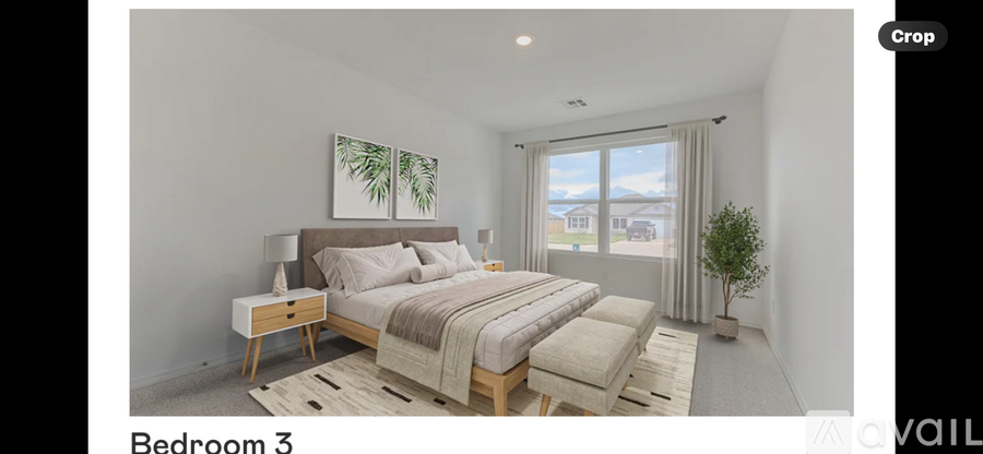 Bedroom 3 has a large bed with a wooden frame and a small plant on the windowsill.