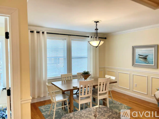 A dining room with a table set for four.
