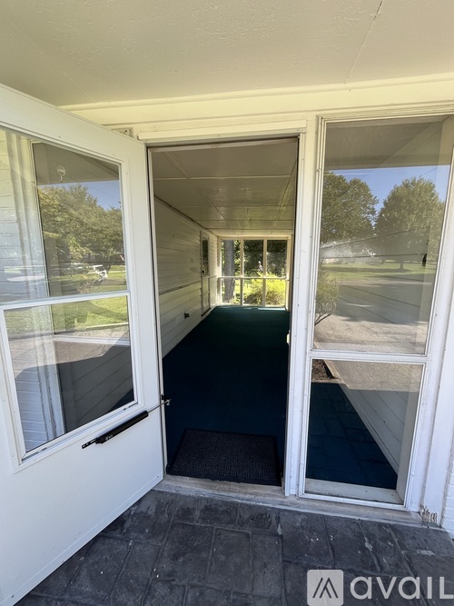 A white door with a glass window is open.