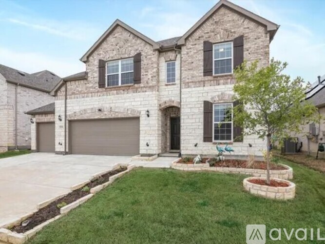A two-story house with a garage and a front yard with a tree.