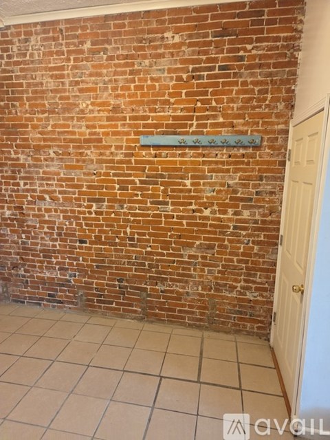 A brick wall with a white door.