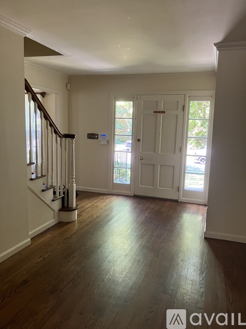 A hallway with a staircase leading to the second floor.