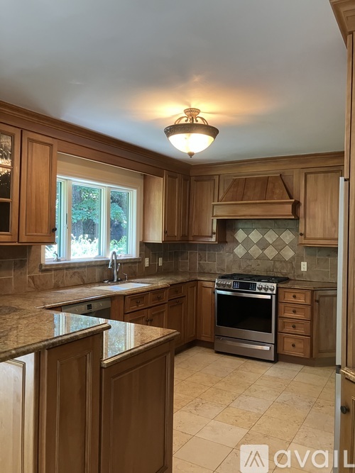A kitchen with wooden cabinets and a tiled backsplash.