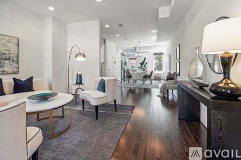 A modern living room with a white sofa and a wooden coffee table.