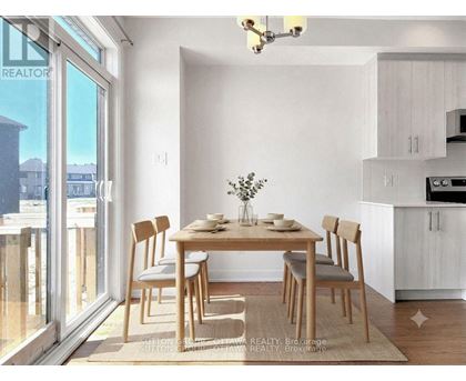 A dining room with a table set for two and a view of the outside.
