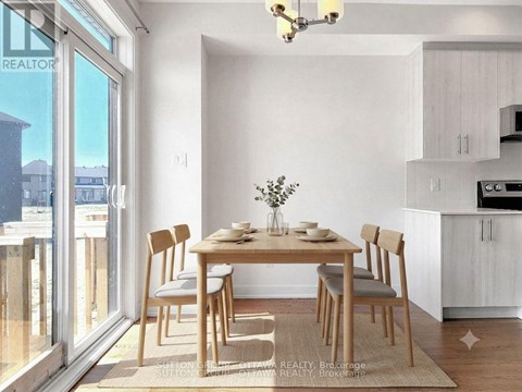 A dining room with a table set for two and a view of the outside.